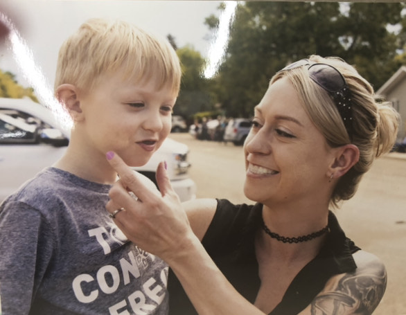 Mallory Milne outdoors with a young child